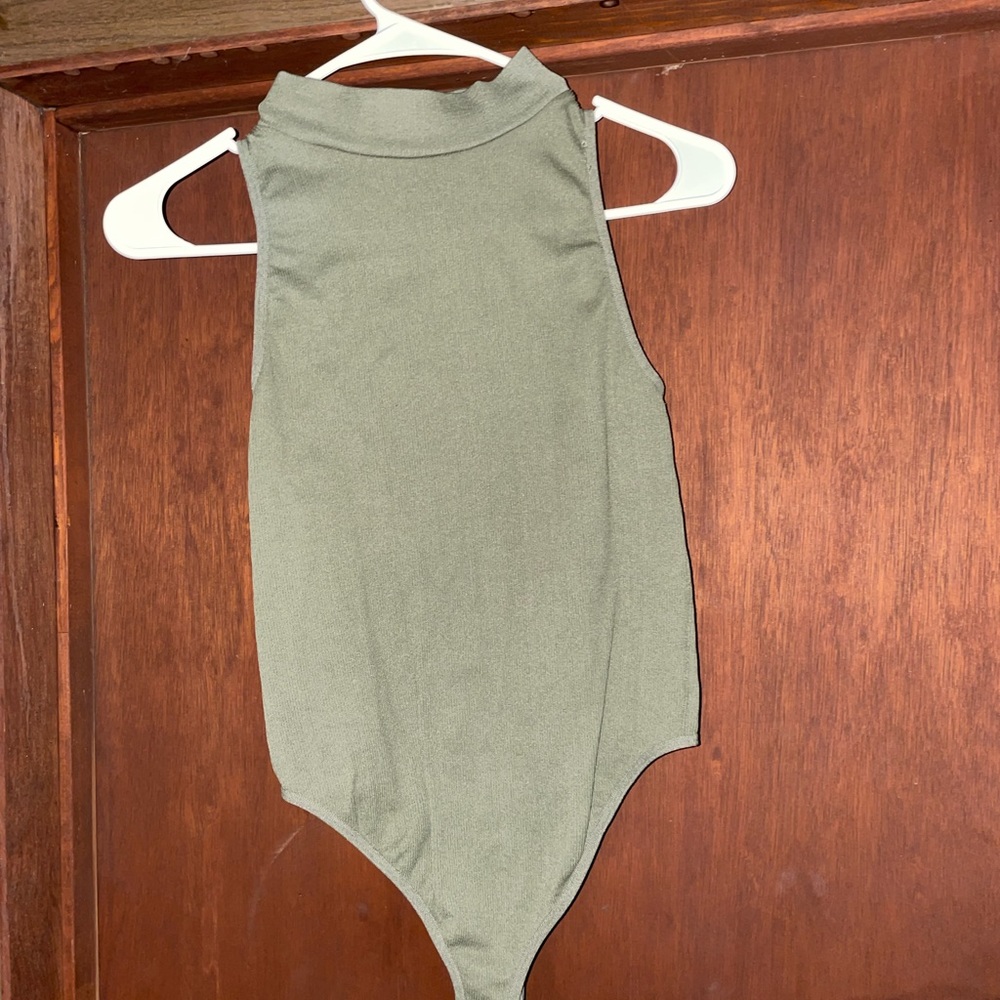 Medium green stretchy one piece. Sleeveless turtleneck. Pairs with Jean jacket.